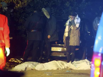 ﻿A girl cries as lifeless bodies lie on the ground outside disco Lanterna Azzurra in Corinaldo, central Italy, Saturday, Dec. 8, 2018. A stampede at a rap concert in an overcrowded disco in central Italy killed five young teenagers and a woman who had accompanied her daughter to the event early Saturday, police said, adding that 59 people were injured. (AP Photo/Bobo Antic)