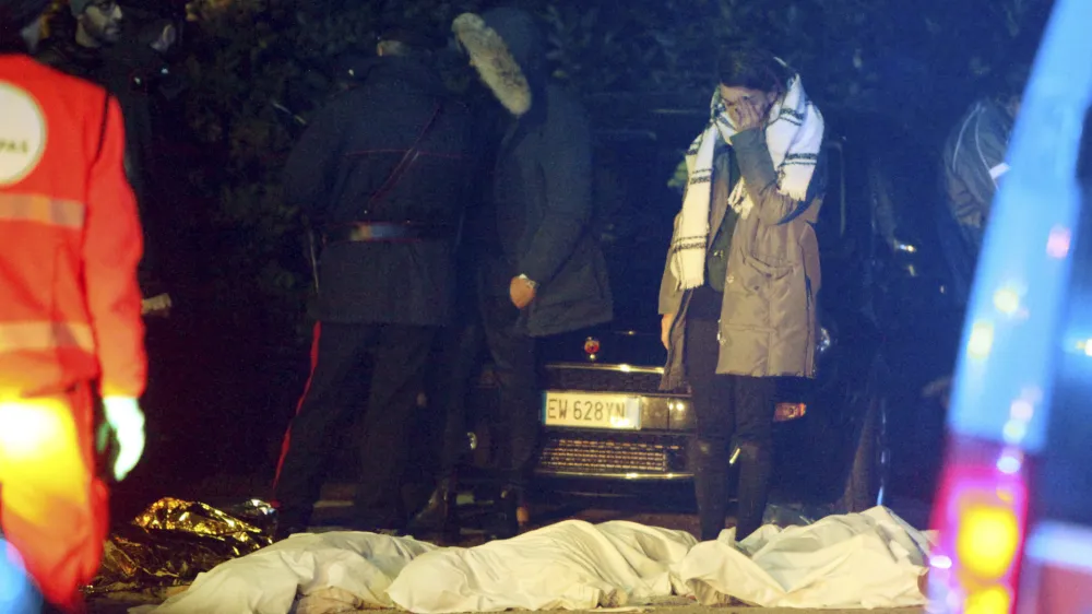 ﻿A girl cries as lifeless bodies lie on the ground outside disco Lanterna Azzurra in Corinaldo, central Italy, Saturday, Dec. 8, 2018. A stampede at a rap concert in an overcrowded disco in central Italy killed five young teenagers and a woman who had accompanied her daughter to the event early Saturday, police said, adding that 59 people were injured. (AP Photo/Bobo Antic)