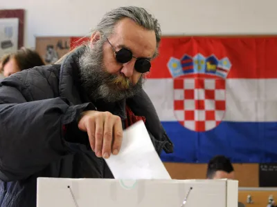 A man casts a ballot in a national referendum at a polling station in Zagreb, January 22, 2012. Croatia voted on Sunday on joining the European Union, a move the government says offers the former Yugoslav republic its only chance of economic recovery despite turmoil in the 27-state bloc. REUTERS/ Davor Kovacevic (CROATIA - Tags: ELECTIONS POLITICS)