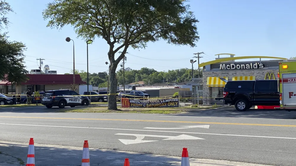 Police vehicles sit parked in front of a McDonald's restaurant as police investigate a shooting in which multiple people were killed Thursday, May 4, 2023, in Moultrie, Ga. The Georgia Bureau of Investigation said Thursday that there is more than one crime scene, including one at the McDonald's restaurant. (Kamira Smith/The Moultrie Observer via AP)