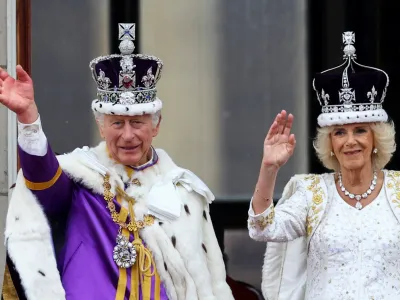 Britain's King Charles and Queen Camilla gesture as they stand on the Buckingham Palace balcony following their coronation ceremony in London, Britain May 6, 2023. REUTERS/Hannah McKay