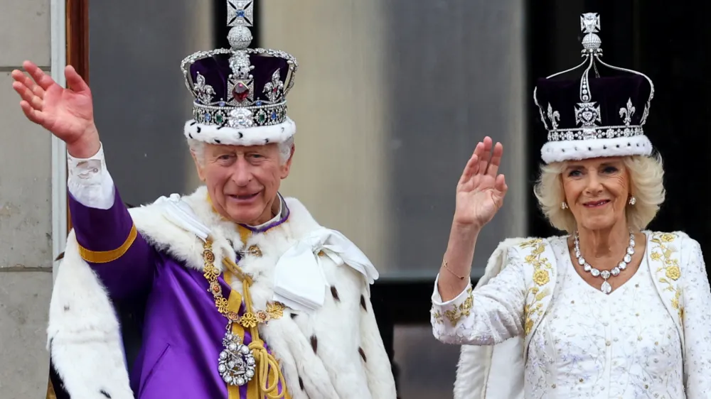 Britain's King Charles and Queen Camilla gesture as they stand on the Buckingham Palace balcony following their coronation ceremony in London, Britain May 6, 2023. REUTERS/Hannah McKay