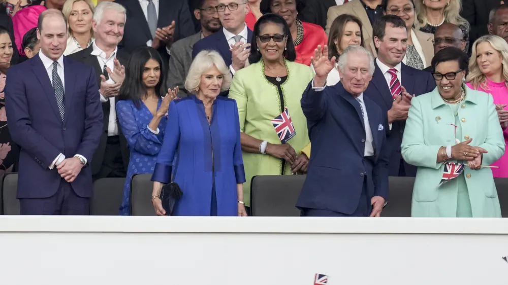 07 May 2023, United Kingdom, Windsor: King Charles III, flanked by Queen Camilla (L) and Patricia Scotland, Baroness Scotland (R), waves from the Royal Box during the Coronation Concert held in the grounds of Windsor Castle, to celebrate the coronation of King Charles III and Queen Camilla. Photo: Kin Cheung/PA Wire/dpa