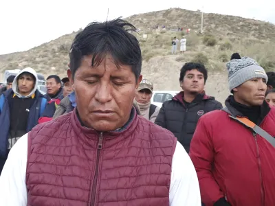 Relatives of trapped miners wait outside the SERMIGOLD mine in Arequipa, Peru, Sunday, May 7, 2023. The Public Ministry confirmed the death of 27 miners, who were trapped early Saturday morning due to an explosion in a tunnel inside the artisanal mine located in Yanaquihua district in Arequipa. (AP Photo/Fernando Mojito)