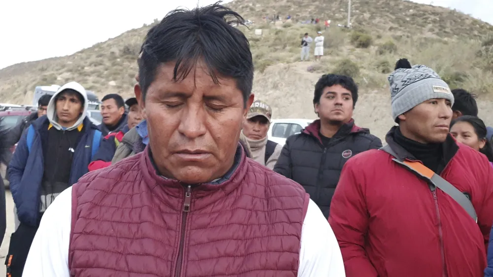 Relatives of trapped miners wait outside the SERMIGOLD mine in Arequipa, Peru, Sunday, May 7, 2023. The Public Ministry confirmed the death of 27 miners, who were trapped early Saturday morning due to an explosion in a tunnel inside the artisanal mine located in Yanaquihua district in Arequipa. (AP Photo/Fernando Mojito)