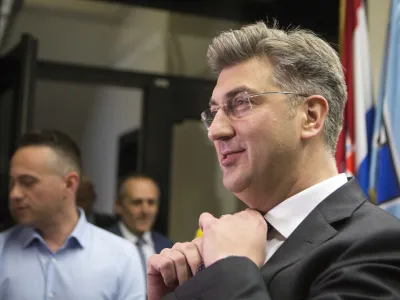 ﻿Croatia's Prime Minister, Andrej Plenkovic, adjusts his tie before addressing the media at his party headquarters in Zagreb, Croatia, Thursday, April 27, 2017. Plenkovic has moved to replace three ministers from a junior party in the government, triggering a crisis in the ruling conservative coalition. (AP Photo/Darko Bandic)