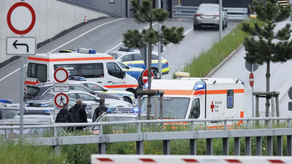 Police emergency vehicles are parked at a Mercedes-Benz plant in Sindelfingen, Germany, Thursday May 11, 2023.. A man opened fire at a Mercedes-Benz factory in southwestern Germany on Thursday, leaving one person dead and another person seriously wounded, German prosecutors confirmed. (Julian Rettig/dpa via AP)