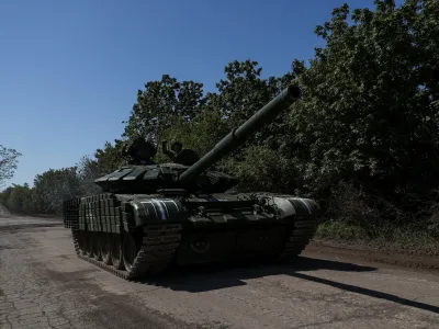 Ukrainian servicemen ride atop of a tank on a road to the frontline town of Bakhmut, amid Russia's attack on Ukraine, in Donetsk region, Ukraine May 12, 2023. REUTERS/Sofiia Gatilova