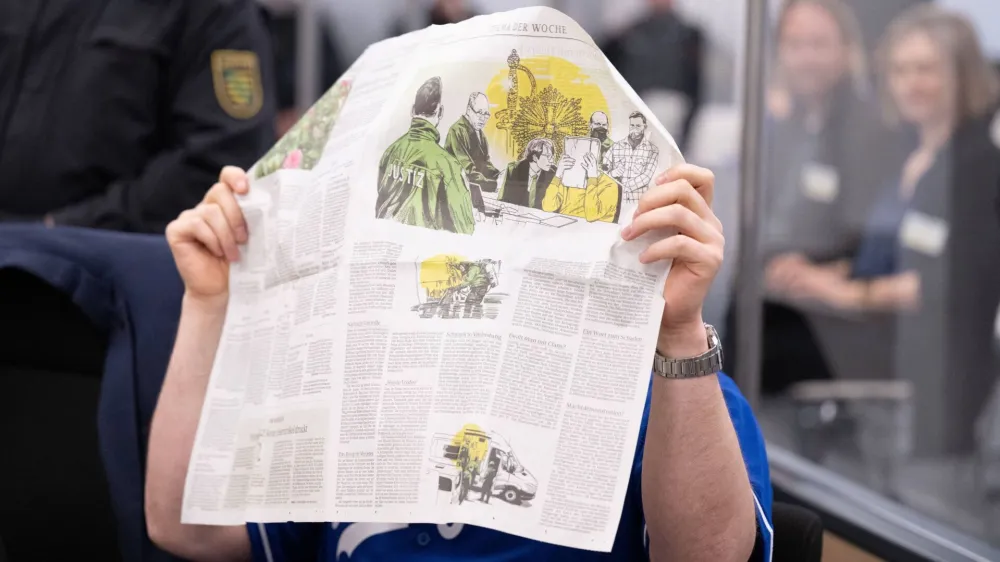 A defendant hides his face in the courtroom of the Higher Regional Court before the verdict over a jewellery heist on the Green Vault museum in Dresden's Royal Palace, in Dresden, Germany on May 16, 2023. Sebastian Kahnert/Pool via REUTERS   ATTENTION EDITORS - PARTS OF THE IMAGE HAVE BEEN PIXELATED AT SOURCE. GERMAN COURT REQUESTS THAT THE FACE OF DEFENDANTS MUST BE MADE UNRECOGNISABLE