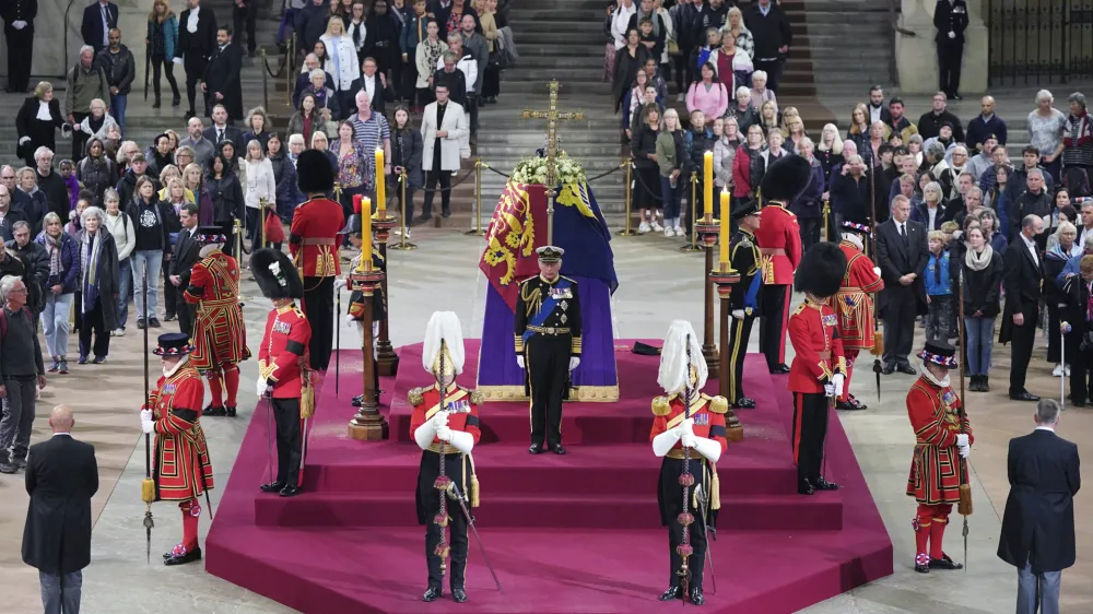 FILE - Members of the public file past as King Charles III, Princess Anne, Prince Andrew and Prince Edward hold a vigil beside the coffin of their mother, Queen Elizabeth II, as it lies in state on the catafalque in Westminster Hall, at the Palace of Westminster, London, Sept. 16, 2022. Queen Elizabeth II's funeral and lying-in-state last year cost Britain's government an estimated 162 million pounds (around $200 million), the treasury said Thursday May 18, 2023. (Yui Mok/Pool Photo via AP, File)