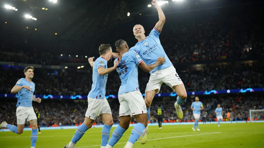 Manchester City's Erling Haaland, right, and his teammates celebrate their third goal during the Champions League semifinal second leg soccer match between Manchester City and Real Madrid at Etihad stadium in Manchester, England, Wednesday, May 17, 2023. (AP Photo/Jon Super)