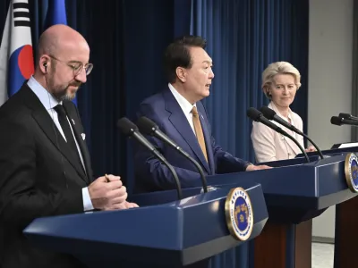 Charles Michel, left, President of the European Council, South Korea's President Yoon Suk Yeol, center, and Ursula von der Leyen, right, President of the European Commission, address the media during a joint press conference after their meeting at the Presidential Office in Seoul, South Korea, Monday, May 22, 2023. (Photo by Jung Yeon-je/Pool Photo via AP)