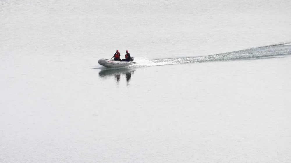 A police dingy navigates in the Arade dam near Silves, Portugal, Tuesday May 23, 2023. Portuguese police said they will resume searching for Madeleine McCann, the British toddler who disappeared in the country's Algarve region in 2007, in the next few days. Portugal's Judicial Police released a statement confirming local media reports that they would conduct the search at the request of the German authorities and in the presence of British officials. (AP Photo/Joao Matos)