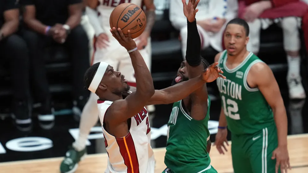 May 23, 2023; Miami, Florida, USA; Miami Heat forward Jimmy Butler (22) shoot against Boston Celtics guard Jaylen Brown (7) in the fourth quarter during game four of the Eastern Conference Finals for the 2023 NBA playoffs at Kaseya Center. Mandatory Credit: Jim Rassol-USA TODAY Sports