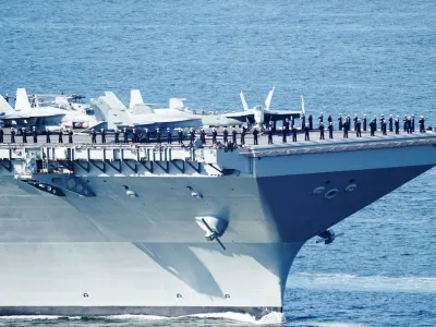 Soldiers protect the U.S. aircraft carrier USS Gerald R. Ford on its way into the Oslo Fjord, at Drobak Moss, Norway, May 24, 2023. Terje Pedersen/NTB/via REUTERS  ATTENTION EDITORS - THIS IMAGE WAS PROVIDED BY A THIRD PARTY. NORWAY OUT. NO COMMERCIAL OR EDITORIAL SALES IN NORWAY. 