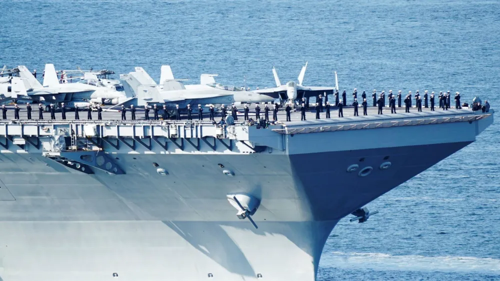 Soldiers protect the U.S. aircraft carrier USS Gerald R. Ford on its way into the Oslo Fjord, at Drobak Moss, Norway, May 24, 2023. Terje Pedersen/NTB/via REUTERS  ATTENTION EDITORS - THIS IMAGE WAS PROVIDED BY A THIRD PARTY. NORWAY OUT. NO COMMERCIAL OR EDITORIAL SALES IN NORWAY. 