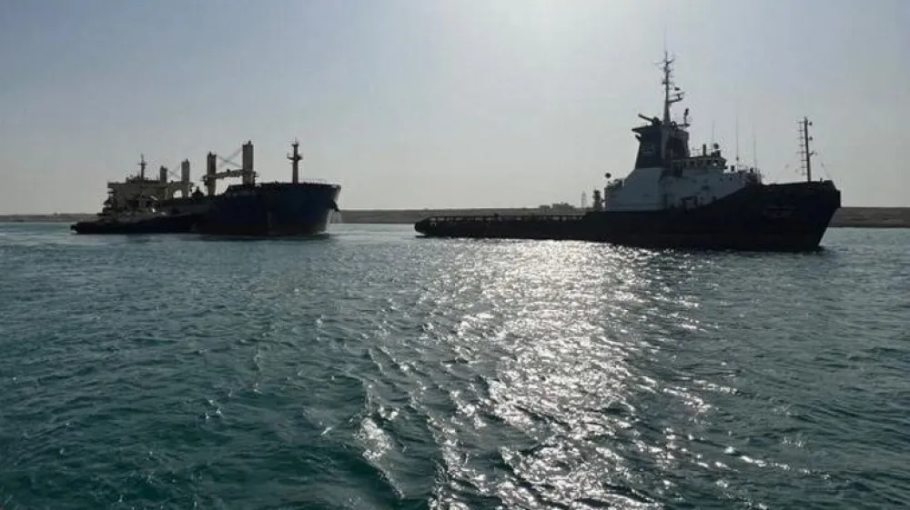 A general view of two tugboats working to refloat a large ship that ran aground at the canal of Ismailia, Egypt, May 25, 2023. The Suez Canal Authority/Handout via REUTERS THIS IMAGE HAS BEEN SUPPLIED BY A THIRD PARTY.