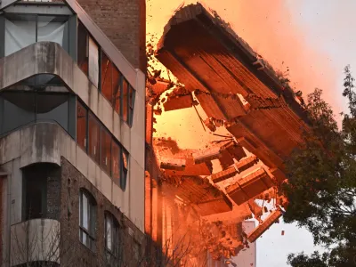 A wall collapses during a building fire in the Central Business District of Sydney, Thursday, May 25, 2023. (AAP Image/Dean Lewins) NO ARCHIVING