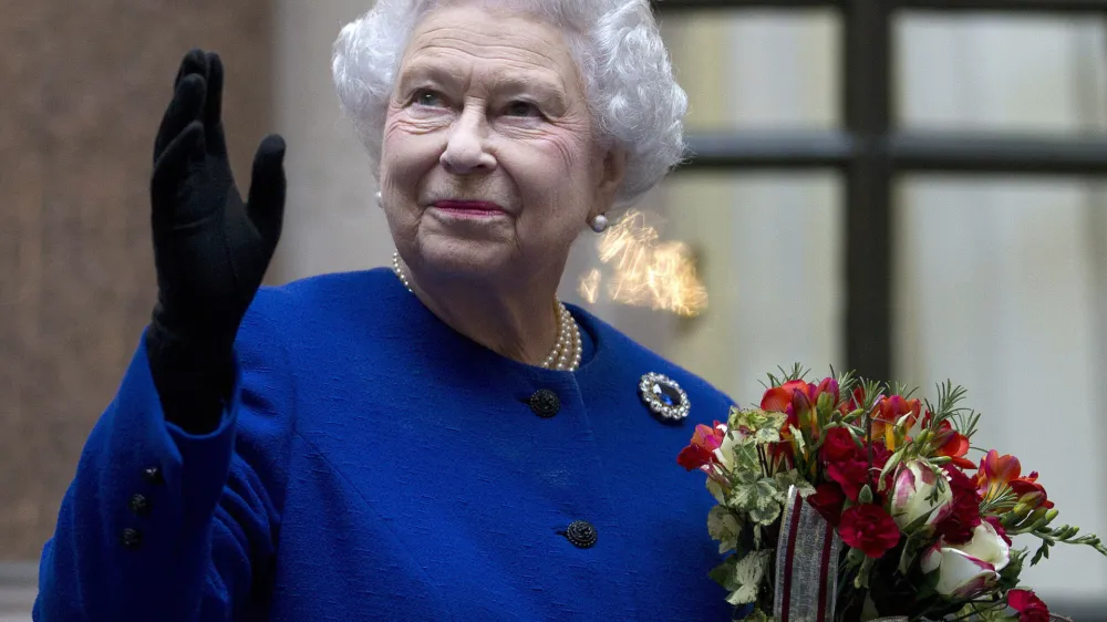 FILE - In this Tuesday, Dec. 18, 2012 file photo, Britain's Queen Elizabeth II looks up and waves to members of staff of The Foreign and Commonwealth Office as she ends an official visit which is part of her Jubilee celebrations in London. Queen Elizabeth II, Britain's longest-reigning monarch and a symbol of stability across much of a turbulent century, has died on Thursday, Sept, 8, 2022. She was 96. (AP Photo/Alastair Grant Pool, File)