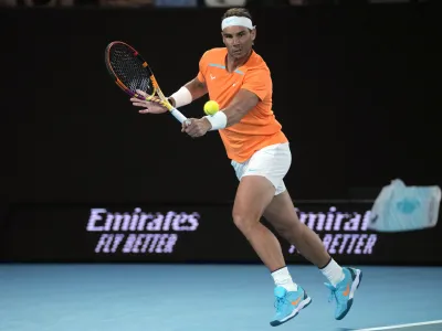 FILE - Rafael Nadal, of Spain, plays a backhand return to Mackenzie McDonald, of the U.S., during their second-round match at the Australian Open tennis championship in Melbourne, Australia, Jan. 18, 2023. Nadal had arthroscopic surgery on Friday, June 2, 2023, for the injured left hip flexor that forced him to sit out the French Open for the first time since he won the first of his record 14 titles there in his 2005 tournament debut. (AP Photo/Dita Alangkara, File)