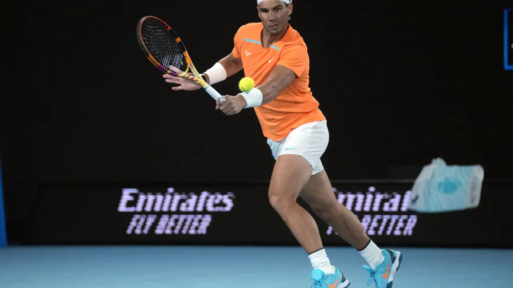 FILE - Rafael Nadal, of Spain, plays a backhand return to Mackenzie McDonald, of the U.S., during their second-round match at the Australian Open tennis championship in Melbourne, Australia, Jan. 18, 2023. Nadal had arthroscopic surgery on Friday, June 2, 2023, for the injured left hip flexor that forced him to sit out the French Open for the first time since he won the first of his record 14 titles there in his 2005 tournament debut. (AP Photo/Dita Alangkara, File)