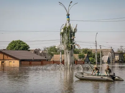 Volunteers sail on a boat during an evacuation of local residents from a flooded area after the Nova Kakhovka dam breached, amid Russia's attack on Ukraine, in Kherson, Ukraine June 7, 2023. REUTERS/Alina Smutko   TPX IMAGES OF THE DAY