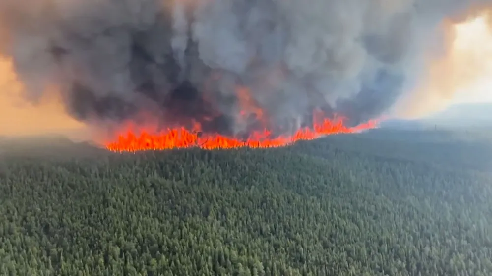 Smoke rises from a wildfire in Tumbler Ridge, British Columbia, Canada, in this screen grab taken from a video, June 8, 2023. BC Wildlife Service/Handout via REUTERS  THIS IMAGE HAS BEEN SUPPLIED BY A THIRD PARTY MANDATORY CREDIT NO RESALES. NO ARCHIVES.