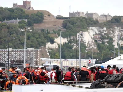 FILE PHOTO: Migrants arrive at Dover harbour onboard a Border Force vessel, after being rescued while attempting to cross the English Channel, in Dover, Britain, August 24, 2022. REUTERS/Henry Nicholls/File Photo