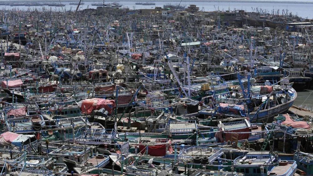 Fishing boats are anchored at a fishing harbor following authorities alerting fishermen of Cyclone Tauktae, in Karachi, Pakistan, Saturday, June 10, 2023. The meteorological department issued an alert, warning fishermen to avoid fishing in the Arabian sea, as the Cyclone Tauktae could cause rough conditions in the sea. (AP Photo/Fareed Khan)