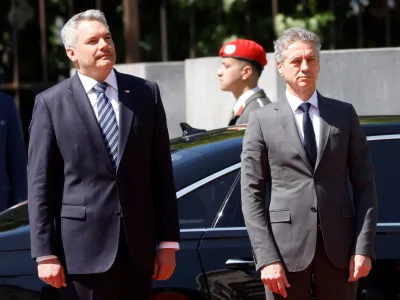 Austrian Chancellor Karl Nehammer and Slovenia's Prime Minister Robert Golob listen to their national anthems in Vienna, Austria, June 13, 2023. REUTERS/Leonhard Foeger