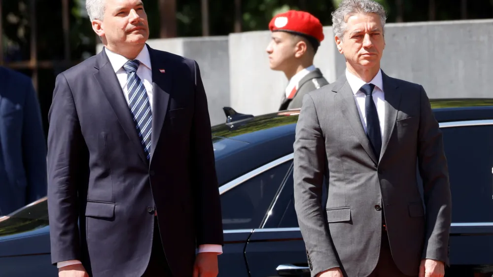 Austrian Chancellor Karl Nehammer and Slovenia's Prime Minister Robert Golob listen to their national anthems in Vienna, Austria, June 13, 2023. REUTERS/Leonhard Foeger