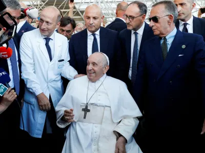 Pope Francis looks on as Dr. Sergio Alfieri, who operated on Pope Francis, stands next to him, after having been discharged from Gemelli Hospital, in Rome, Italy, June 16, 2023. REUTERS/Remo Casilli   TPX IMAGES OF THE DAY