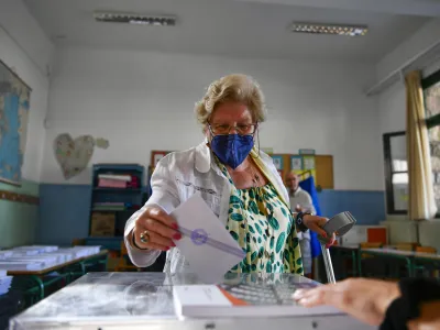 A woman votes at a polling station in Athens, Greece, Sunday, June 25, 2023. Polls have opened in Greece for the second general election in less than two months, with the conservative party a strong favorite to win with a wide majority. (AP Photo/Michael Varaklas)