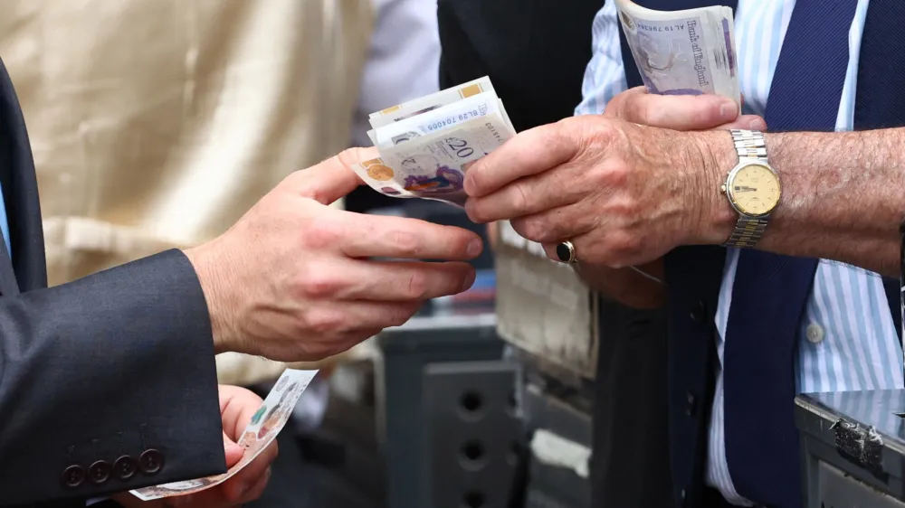 Horse Racing - Royal Ascot - Ascot Racecourse, Ascot, Britain - June 24, 2023 General view as money is handed over at Royal Ascot after the 15:05 Jersey Stakes REUTERS/Andrew Boyers