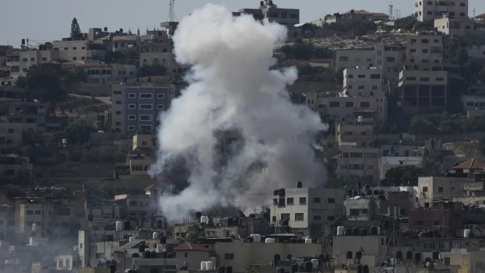 Smoke rises during an Israeli military raid of the militant stronghold of Jenin in the occupied West Bank, Monday, July 3, 2023. Palestinian health officials say at least three Palestinians were killed in the raid. (AP Photo/Majdi Mohammed)