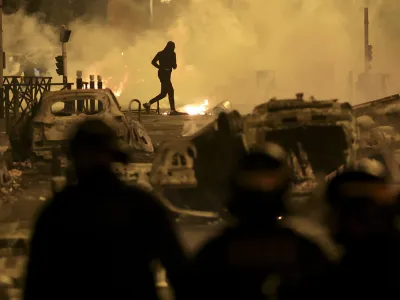 FILE - A demonstrator runs on the third night of protests sparked by the fatal police shooting of a 17-year-old driver in the Paris suburb of Nanterre, France, Friday, June 30, 2023. After more than 3,400 arrests and signs that the violence is now abating, France is once again facing a reckoning. (AP Photo/Aurelien Morissard, File)