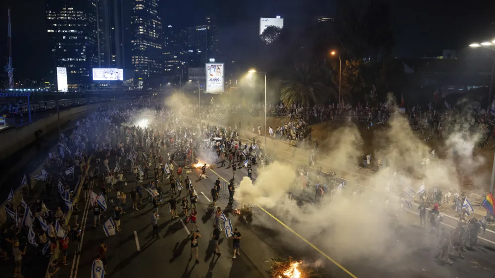 Israelis protest against plans by Prime Minister Benjamin Netanyahu's government to overhaul the judicial system, block the freeway in Tel Aviv, Israel, Wednesday, July 5, 2023. Thousands of protesters have blocked Tel Aviv's main highway and major intersections across Israel in a spontaneous outburst of anger following the ouster of the city's popular police chief. (AP Photo/Oded Balilty)