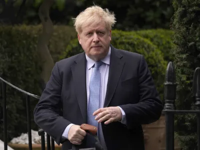 FILE - Boris Johnson leaves his house in London, on March 22, 2023. Former Prime Minister Boris Johnson deliberately misled Parliament about the lockdown-flouting parties that undermined his credibility and contributed to his downfall, a committee of lawmakers said Thursday, June 15, 2023 after a year-long investigation. (AP Photo/Alberto Pezzali, File)