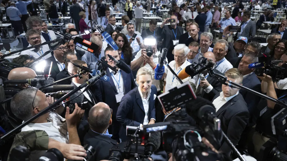 FILE - AfD's Alice Weidel, centre, answers journalists' questions after her election as the second, equal federal spokeswoman at the AfD's federal party conference in Riesa, Germany, June 18, 2022. Prominent members of German mainstream parties have expressed alarm at a new poll released Thursday June 1, 2023, showing support for the far-right Alternative for Germany at a record high. (Sebastian Kahnert/dpa via AP, File)