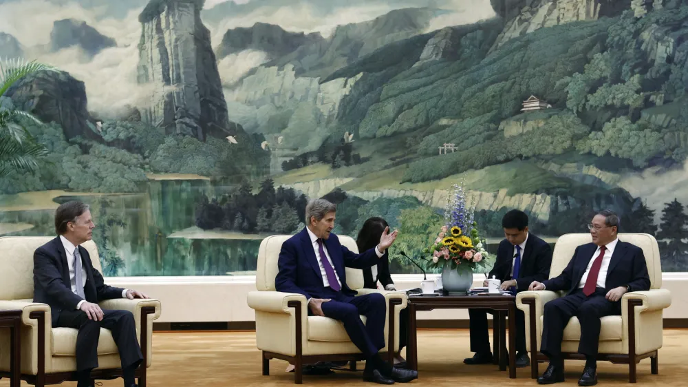 U.S. Special Presidential Envoy for Climate John Kerry, center, attends a meeting with Chinese Premier Li Qiang, right, at the Great Hall of the People in Beijing Tuesday, July 18, 2023. (Florence Lo/Pool Photo via AP)