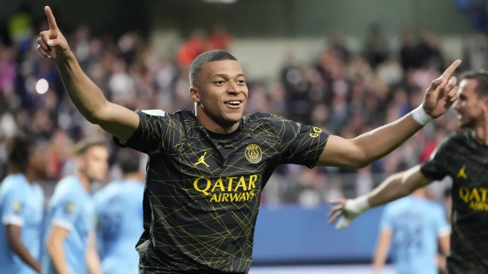 FILE - PSG's Kylian Mbappe celebrates after scoring his side's opening goal during the French League One soccer match between Troyes and Paris Saint Germain, at the Stade de l'Aube, in Troyes, France, Sunday, May 7, 2023. Saudi Arabian soccer team Al-Hilal has made a record $332 million bid for France striker Kylian Mbappe. Paris Saint-Germain has confirmed the offer and says it has given Al-Hilal permission to open negotiations directly with Mbappe. (AP Photo/Lewis Joly, File)