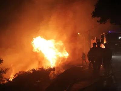 ﻿Firefighters spray water as they try to douse a fire near the village of Biguglia, Corsica island, France, Tuesday, July 25, 2017. Hundreds of firefighters are battling blazes fanned by high winds in more than a dozen zones in the Riviera region of southern France. (AP Photo/Raphael Poletti)