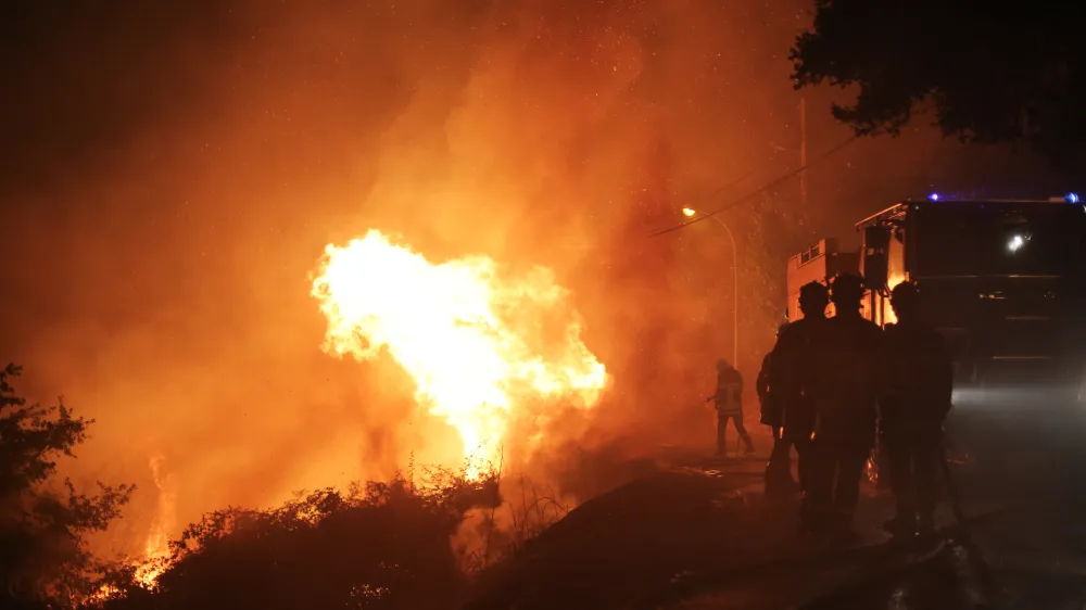 ﻿Firefighters spray water as they try to douse a fire near the village of Biguglia, Corsica island, France, Tuesday, July 25, 2017. Hundreds of firefighters are battling blazes fanned by high winds in more than a dozen zones in the Riviera region of southern France. (AP Photo/Raphael Poletti)