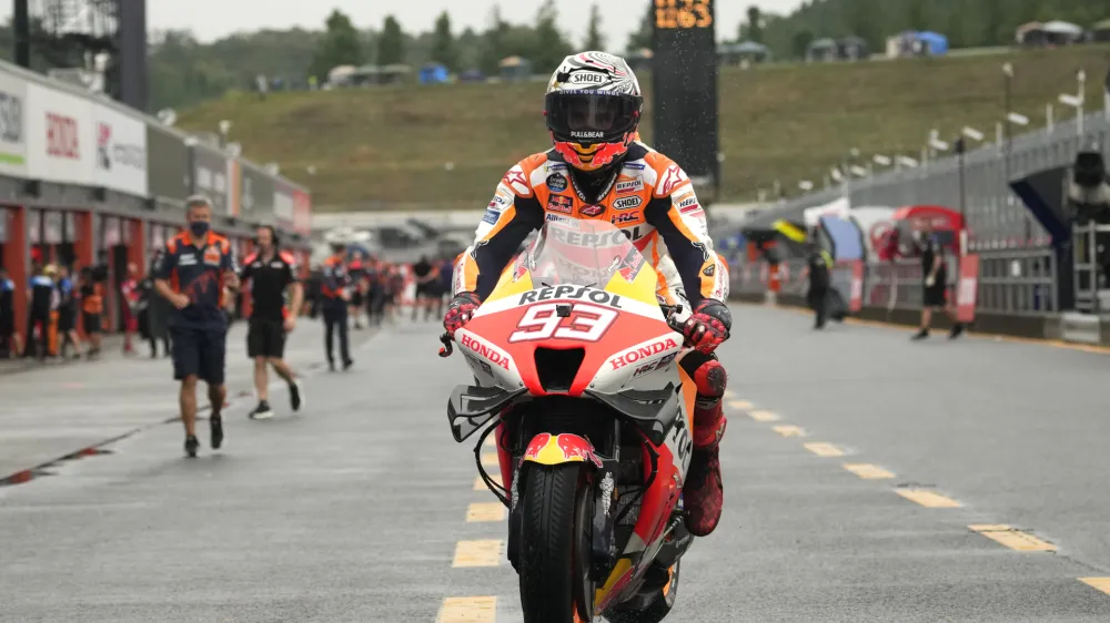 Spanish MotoGP rider Marc Marquez returns to the pitlane after taking pole position during the qualifying round of the Japanese Motorcycle Grand Prix at the Twin Ring Motegi circuit in Motegi, north of Tokyo Saturday, Sept. 24, 2022.(AP Photo/Shuji Kajiyama)