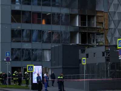 Emergencies services members gather outside the damaged office building in the Moscow City following a reported Ukrainian drone attack in Moscow, Russia, July 30, 2023. REUTERS/Stringer