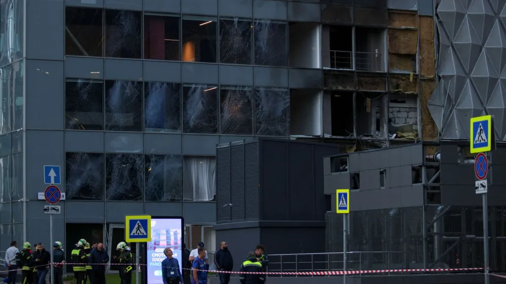 Emergencies services members gather outside the damaged office building in the Moscow City following a reported Ukrainian drone attack in Moscow, Russia, July 30, 2023. REUTERS/Stringer