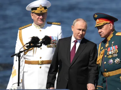 HANDOUT - 30 July 2023, Russia, Saint Petersburg: Russian President Vladimir Putin (C) stands with Russian Defence Minister Sergei Shoigu (R) and Russian Navy Admiral Nikolai Yevmenov during the Naval Parade marking the Russian Navy Day. Photo: -/Kremlin/dpa - ATTENTION: editorial use only and only if the credit mentioned above is referenced in full