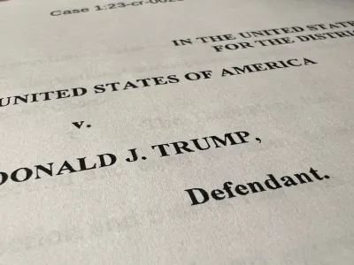 The opening page of an indictment against former U.S. President Donald Trump is seen after he was hit with criminal charges for a third time in four months - this time arising from efforts to overturn his 2020 U.S. election defeat, in a photo illustration August 1, 2023. REUTERS/Kevin Fogarty/Photo Illustration