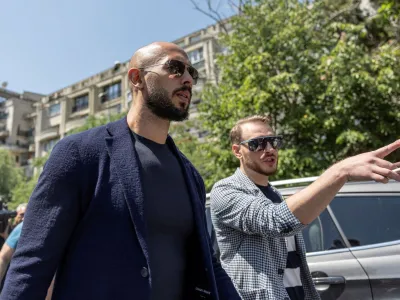 FILE PHOTO: Andrew Tate chats with his lawyer after he appeared in front of a judge at the Bucharest Courthouse, in Bucharest, Romania, July 17, 2023. Inquam Photos/Alexandru Busca via REUTERS ATTENTION EDITORS - THIS IMAGE WAS PROVIDED BY A THIRD PARTY. ROMANIA OUT. NO COMMERCIAL OR EDITORIAL SALES IN ROMANIA/File Photo