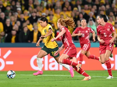 Sam Kerr of Australia (left) in action during the FIFA Women's World Cup 2023 Round of 16 soccer match between Australia and Denmark at Stadium Australia in Sydney, Monday, August 7, 2023. (AAP Image/Dean Lewins) NO ARCHIVING, EDITORIAL USE ONLY